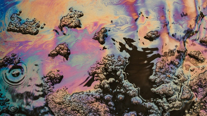 Iridescent oil slick with colorful patterns and textures